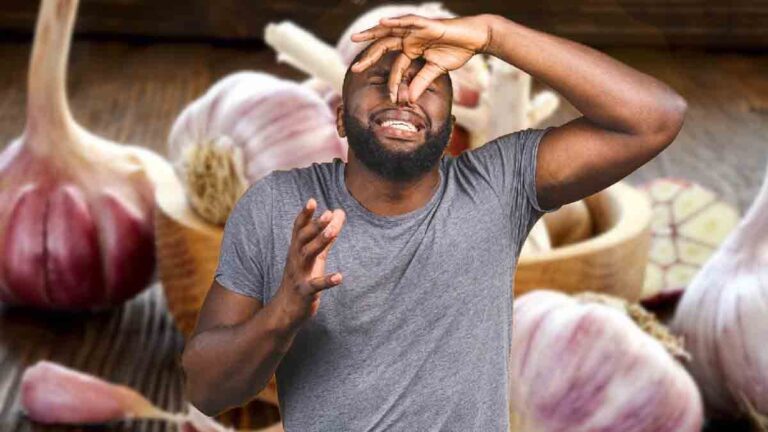 How can you effectively eliminate the smell of garlic or onion from your fingers?