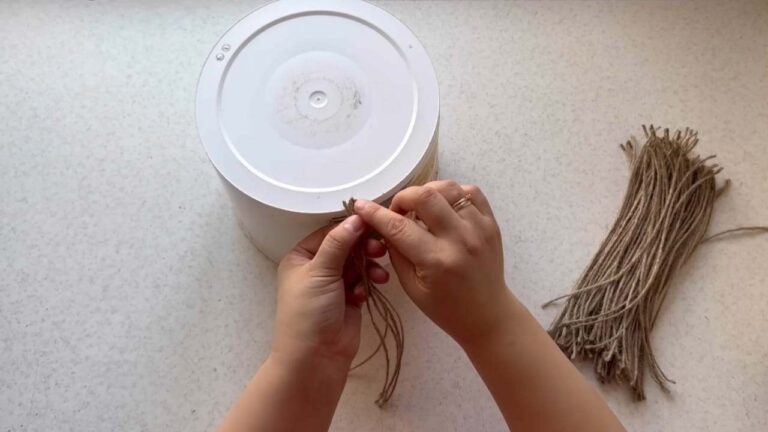 Finds an old plastic bucket in the garbage, turns it into something unique